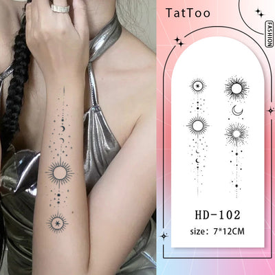 "Little Universe celestial sun, star, and moon temporary tattoo design on arm, inspired by night sky's beauty and mystery"